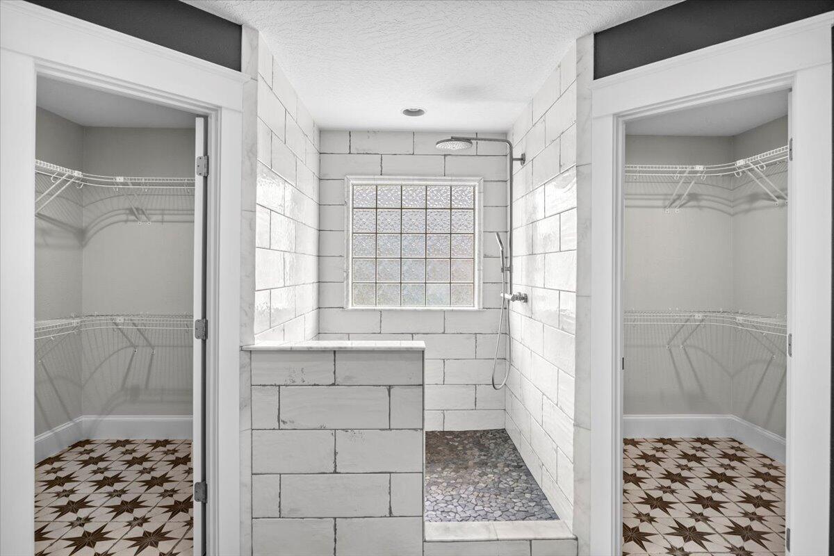 7584 Woodmont Road Navarre, FL 32566 - Photo 21 of 62 a bathroom with a shower and a sink