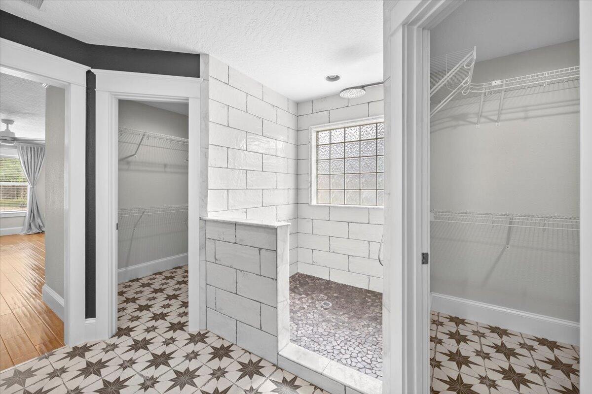 7584 Woodmont Road Navarre, FL 32566 - Photo 22 of 62 a bathroom with a shower and a sink