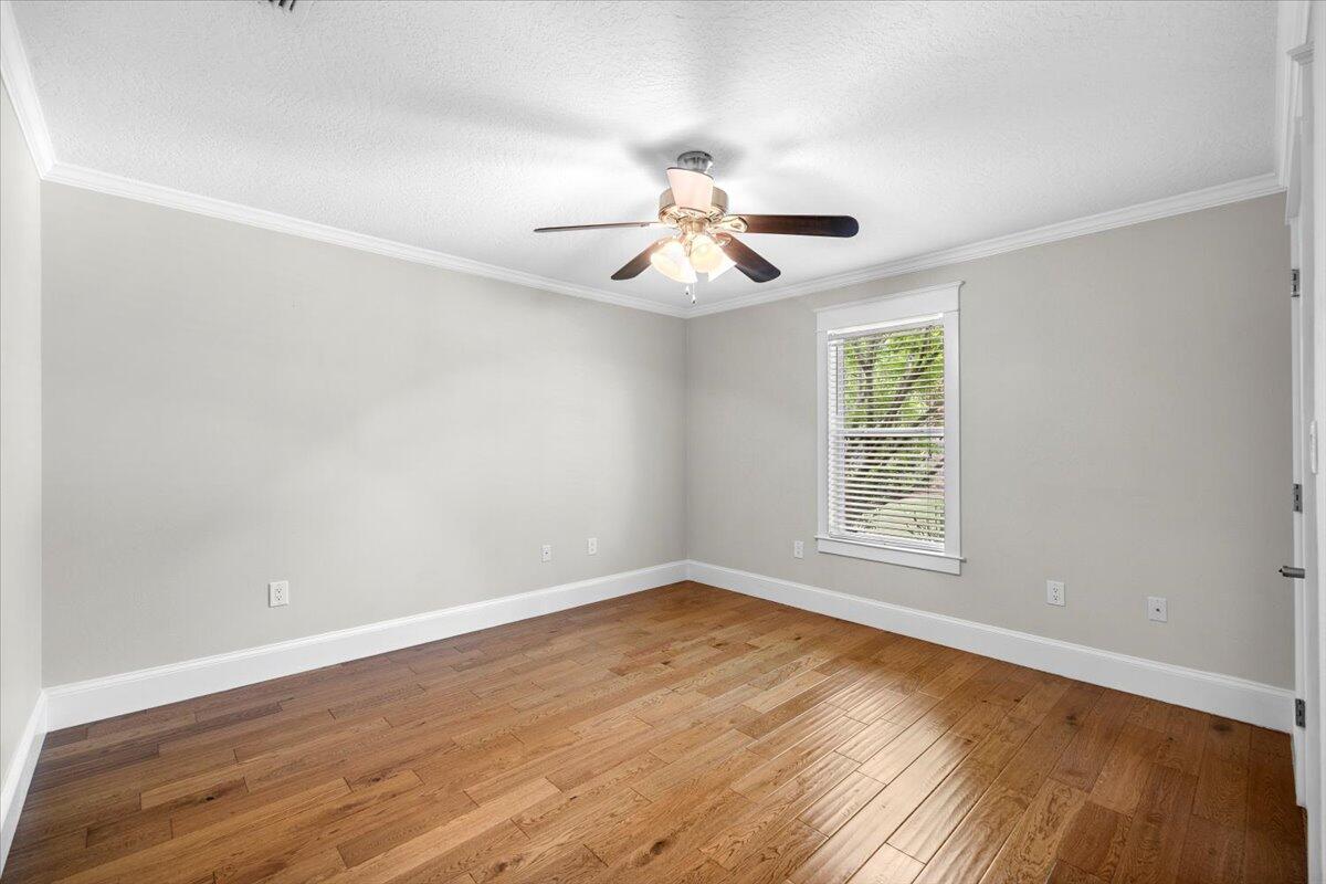 7584 Woodmont Road Navarre, FL 32566 - Photo 31 of 62 wooden floor in an empty room with a window