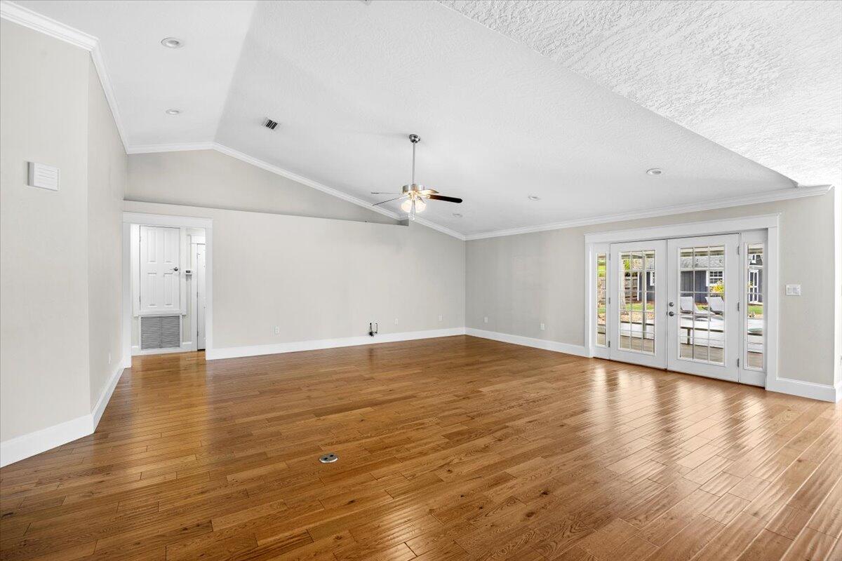 7584 Woodmont Road Navarre, FL 32566 - Photo 32 of 62 a view of an empty room with window and wooden floor