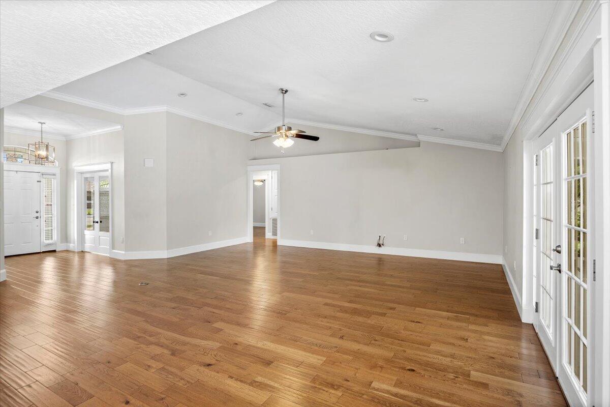 7584 Woodmont Road Navarre, FL 32566 - Photo 33 of 62 wooden floor in an empty room with a window