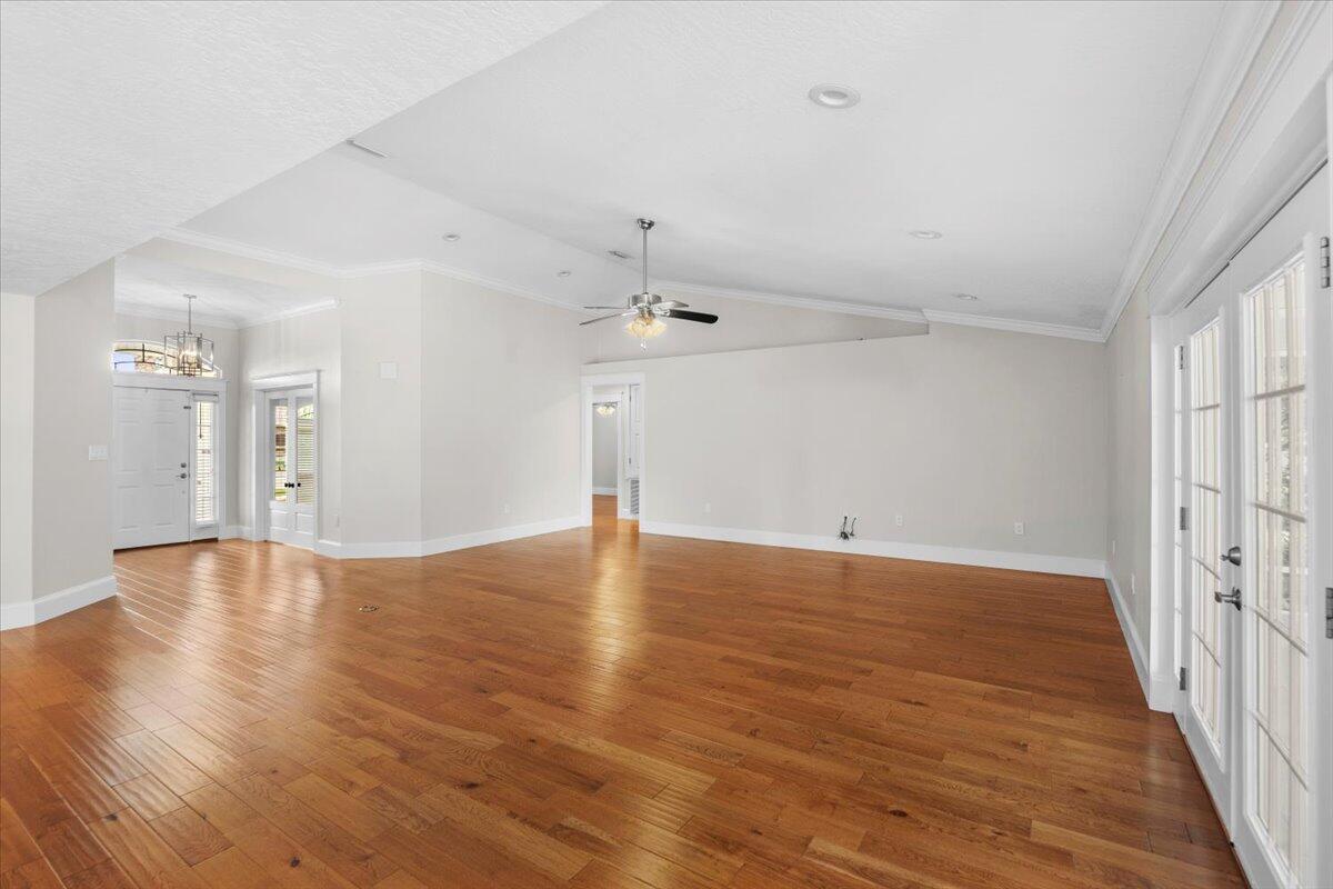 7584 Woodmont Road Navarre, FL 32566 - Photo 34 of 62 wooden floor in an empty room with a window