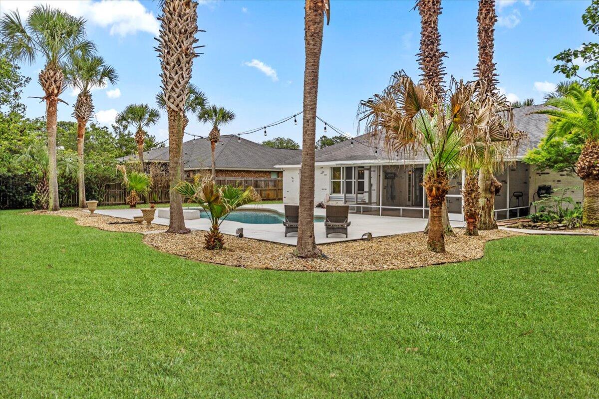 7584 Woodmont Road Navarre, FL 32566 - Photo 4 of 62 a view of a house with a yard and tree s