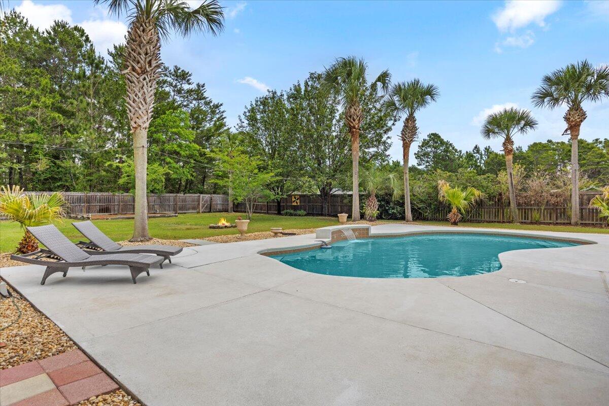 7584 Woodmont Road Navarre, FL 32566 - Photo 47 of 62 a view of outdoor space yard swimming pool and patio