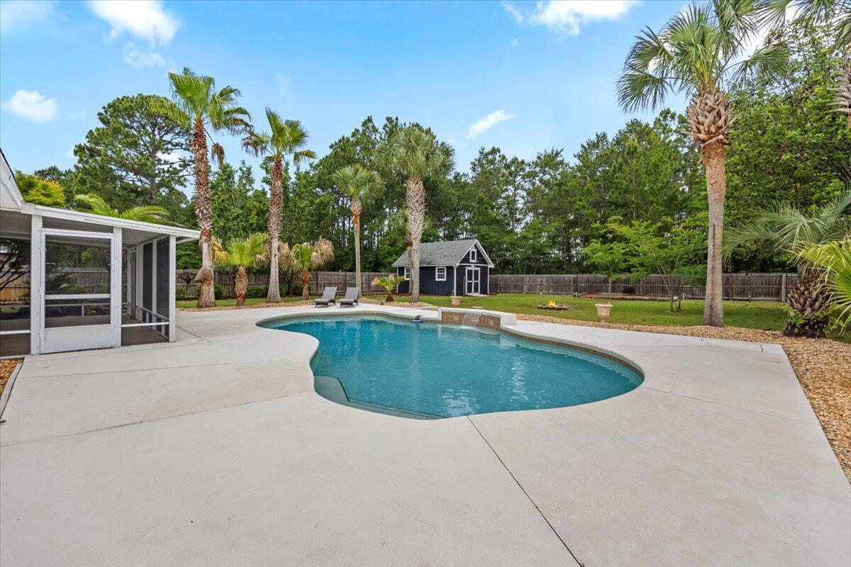 7584 Woodmont Road Navarre, FL 32566 - Photo 48 of 62 a view of a swimming pool with a yard