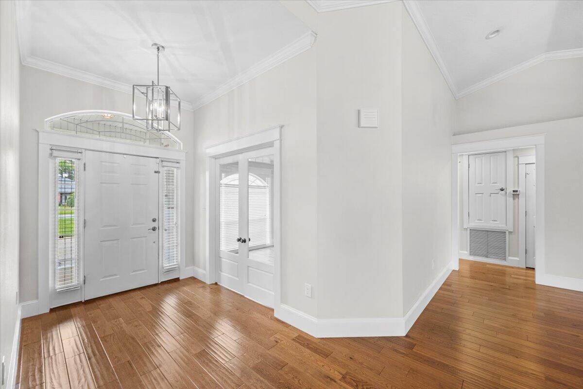 7584 Woodmont Road Navarre, FL 32566 - Photo 6 of 62 a view of empty room with wooden floor and window