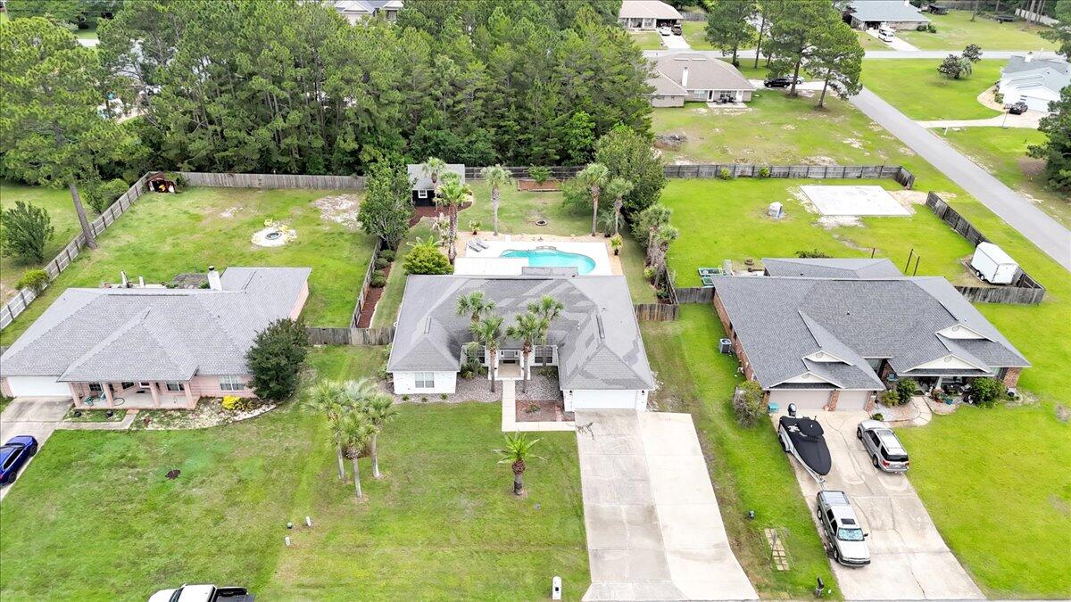 7584 Woodmont Road Navarre, FL 32566 - Photo 61 of 62 an aerial view of residential houses with outdoor space and swimming pool