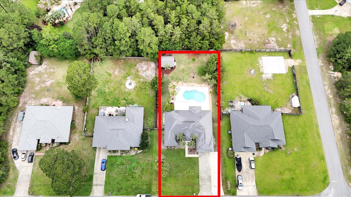 7584 Woodmont Road Navarre, FL 32566 - Photo 62 of 62 an aerial view of residential houses with outdoor space and street view