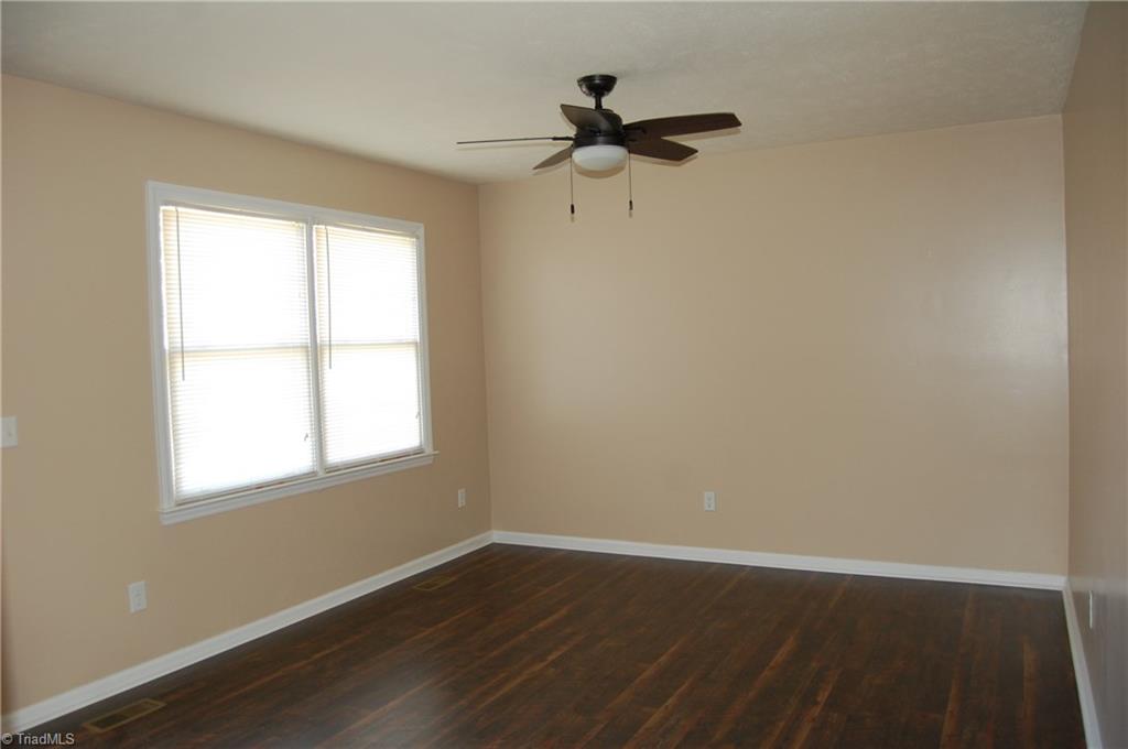 141 Maple Ridge Drive King, NC 27021 - Photo 2 of 20 Living room with fresh paint, laminate flooring and new ceiling fan.