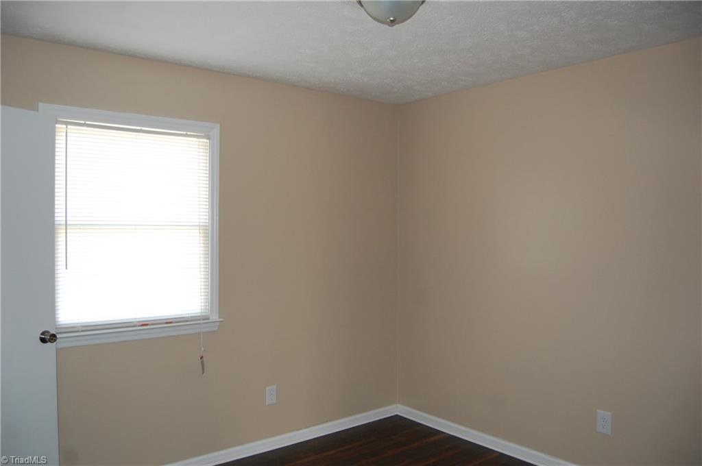 141 Maple Ridge Drive King, NC 27021 - Photo 11 of 20 Bedroom 3 with fresh paint, laminate flooring and overhead lighting