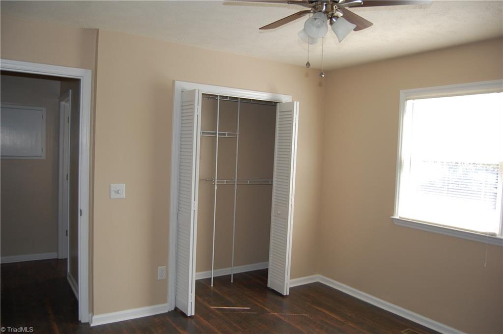 141 Maple Ridge Drive King, NC 27021 - Photo 9 of 20 Master bedroom with fresh paint, laminate flooring and new ceiling fan.