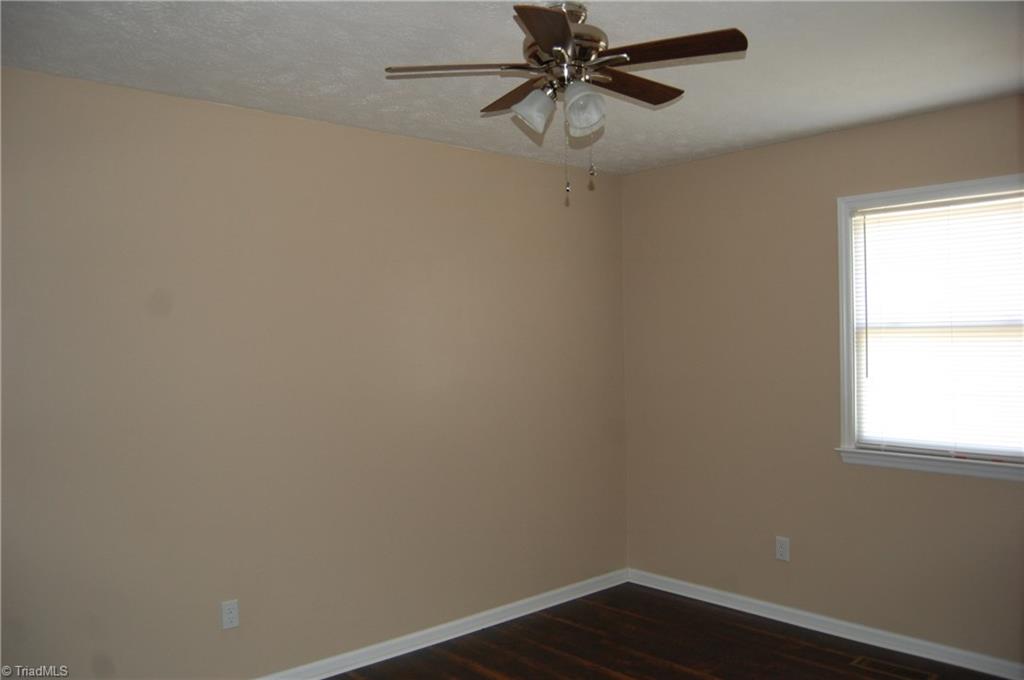 141 Maple Ridge Drive King, NC 27021 - Photo 10 of 20 Bedroom 2 with fresh paint, laminate flooring and new ceiling fan.