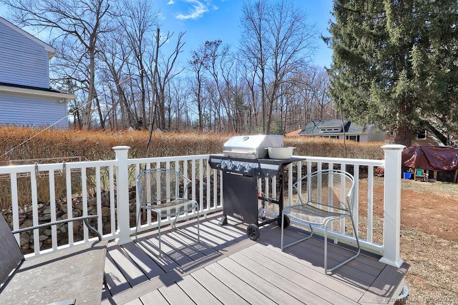 78 Birdseye Road Farmington, CT 06032 - Photo 24 of 28 a view of a wooden deck with furniture and trees
