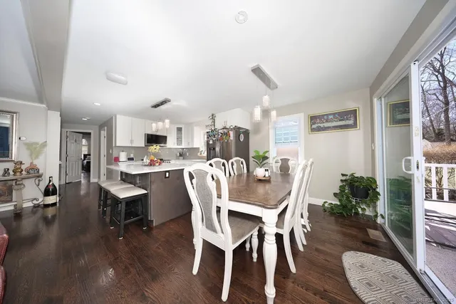 a dining room with furniture and wooden floor
