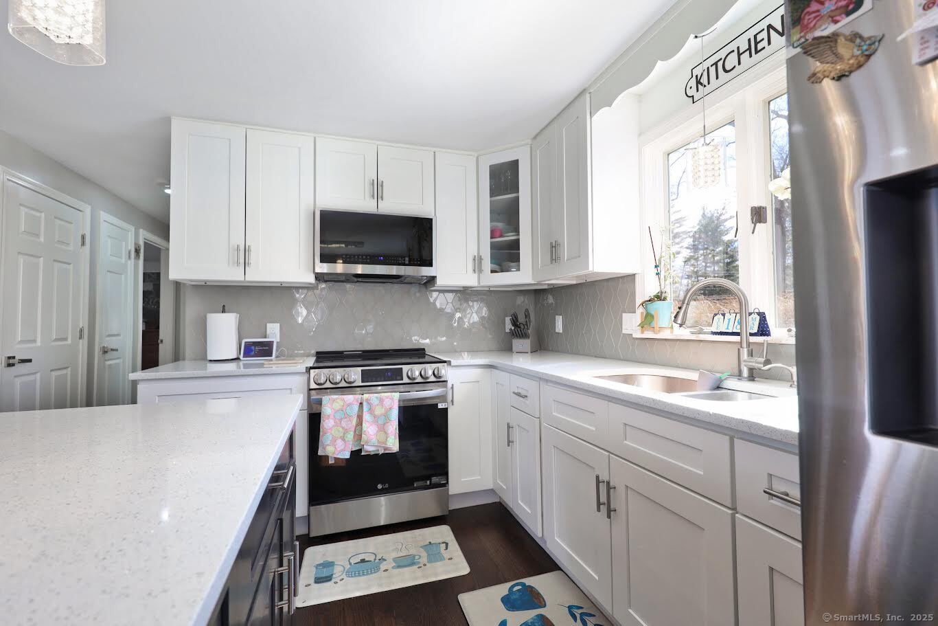 78 Birdseye Road Farmington, CT 06032 - Photo 9 of 28 a kitchen with a stove a sink and a microwave