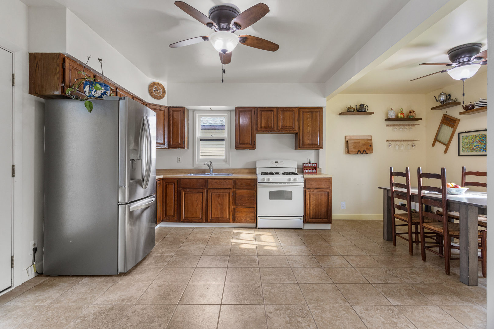 506 East State Street Mahomet, IL 61853 - Photo 11 of 36 a kitchen with stainless steel appliances a stove a refrigerator a sink a dining table and chairs