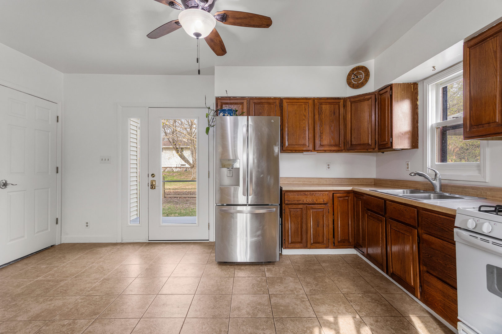 506 East State Street Mahomet, IL 61853 - Photo 14 of 36 a kitchen with a refrigerator a sink and cabinets