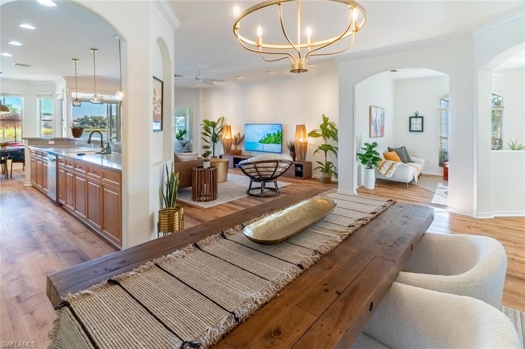 1896 Crestview Way Naples, FL 34119 - Photo 11 of 38 a living room with furniture and a chandelier