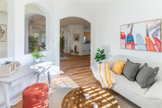a living room with furniture and a potted plant