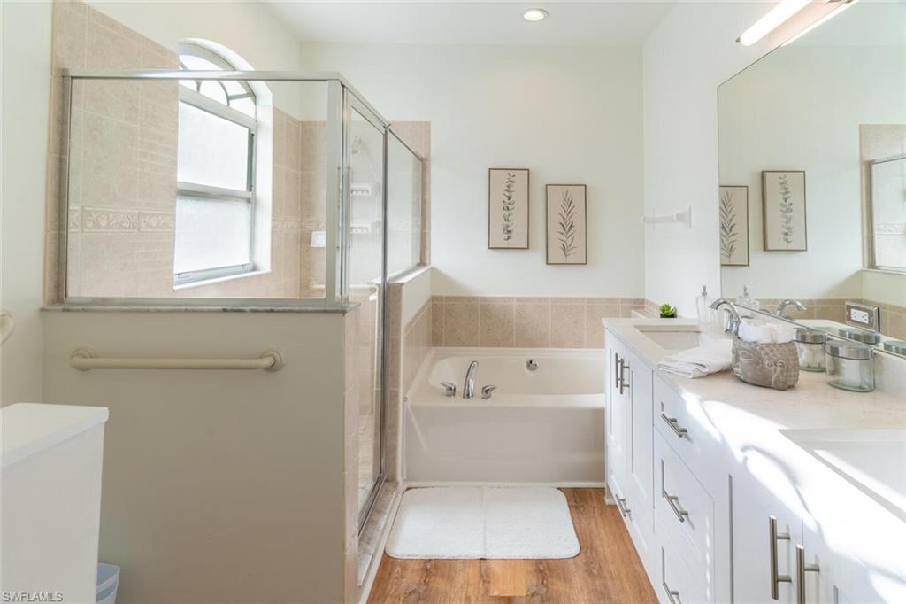 1896 Crestview Way Naples, FL 34119 - Photo 21 of 38 a bathroom with a tub a sink and a window