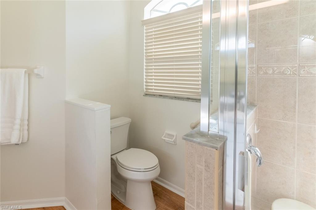 1896 Crestview Way Naples, FL 34119 - Photo 22 of 38 a bathroom with a toilet and a shower