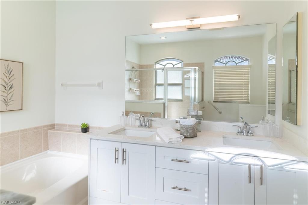 1896 Crestview Way Naples, FL 34119 - Photo 23 of 38 a bathroom with a sink and a mirror