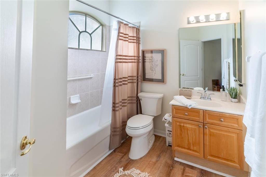 1896 Crestview Way Naples, FL 34119 - Photo 28 of 38 a bathroom with a toilet sink and mirror