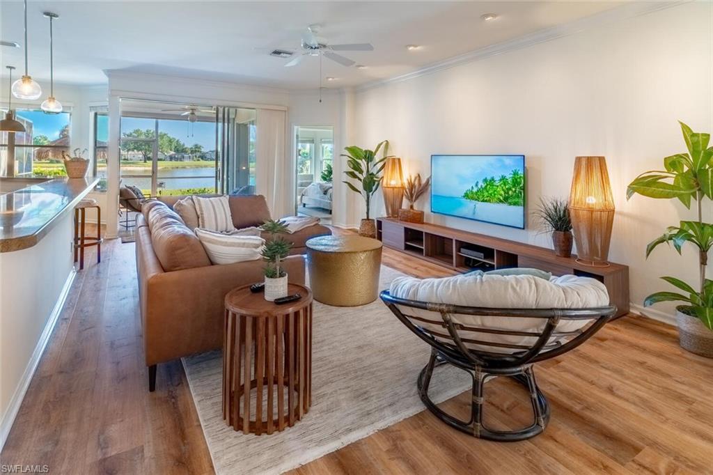 1896 Crestview Way Naples, FL 34119 - Photo 3 of 38 a living room with furniture a flat screen tv and a large window