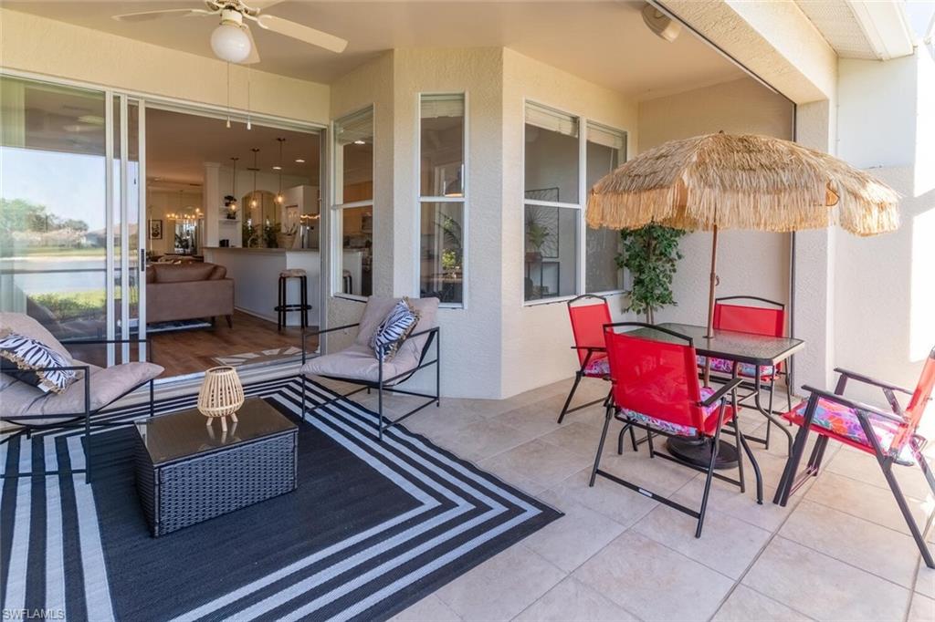 1896 Crestview Way Naples, FL 34119 - Photo 32 of 38 a outdoor space with patio the couches and a dining table with the view of the balcony