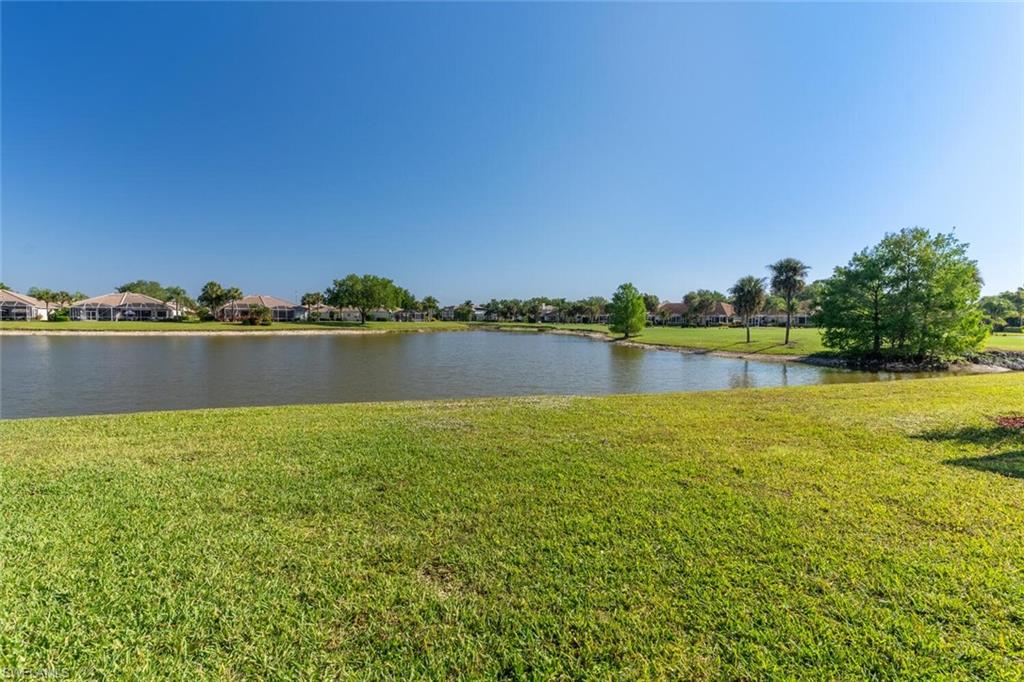 1896 Crestview Way Naples, FL 34119 - Photo 34 of 38 a view of a lake with houses in the background