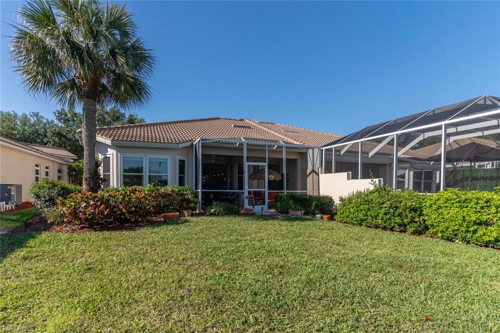 1896 Crestview Way Naples, FL 34119 - Photo 35 of 38 front view of a house with a garden