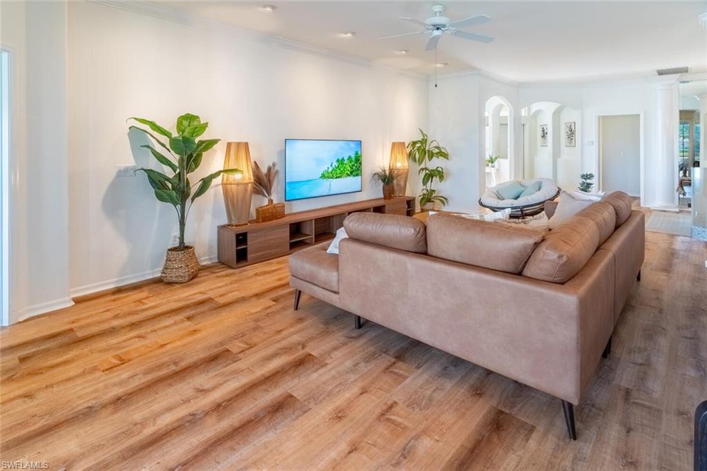 1896 Crestview Way Naples, FL 34119 - Photo 5 of 38 a living room with furniture a potted plant and a wooden floor