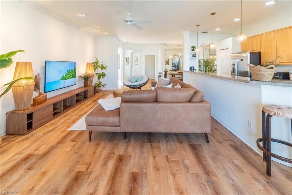 1896 Crestview Way Naples, FL 34119 - Photo 6 of 38 a living room with furniture and a wooden floor
