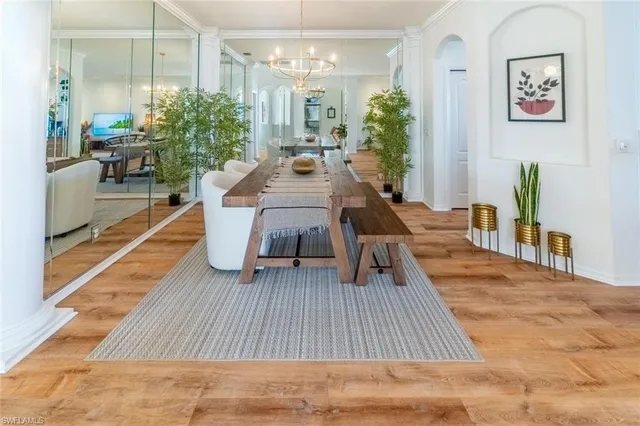 a living room with furniture rug and wooden floor