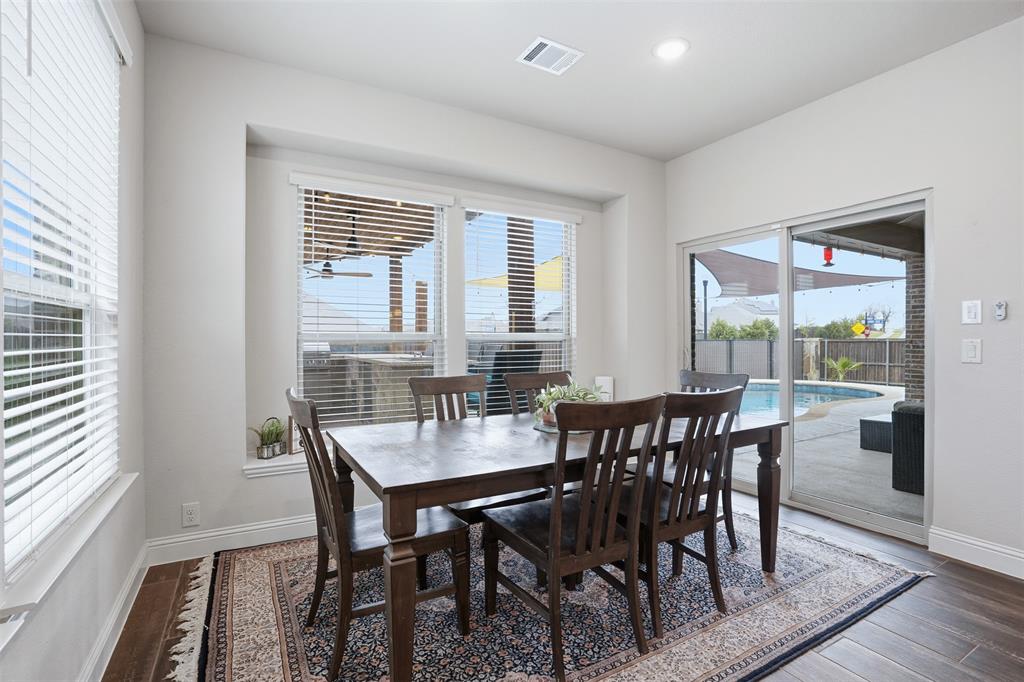 4002 Grove Valley Road Midlothian, TX 76065 - Photo 15 of 40 a view of a dining room with furniture and wooden floor