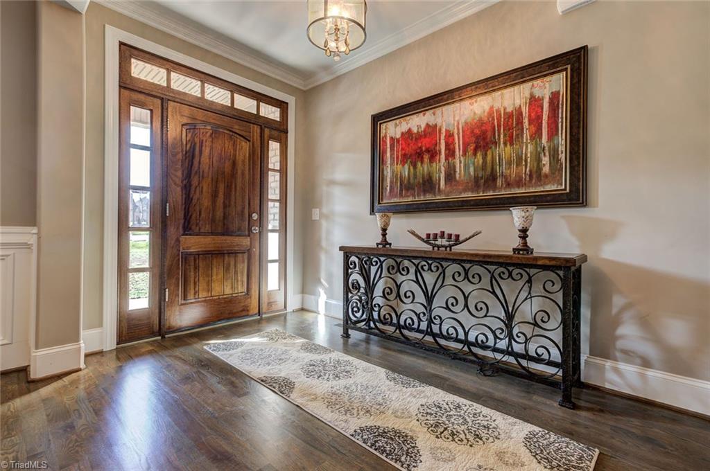 7500 Hearthridge Court Oak Ridge, NC 27310 - Photo 2 of 30 A welcoming foyer. Notice all the high end details throughout this home including hardwood floors, crown molding, and elegant touches.