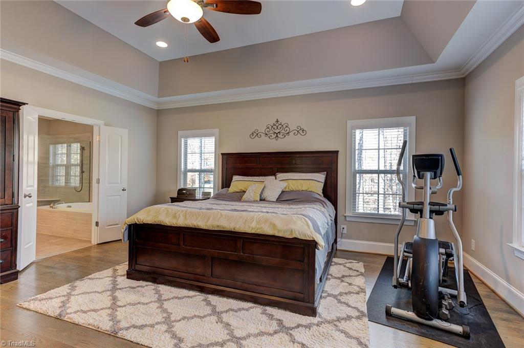 7500 Hearthridge Court Oak Ridge, NC 27310 - Photo 15 of 30 Master bedroom with trey ceiling detail, private ensuite bath and huge walk in closet.