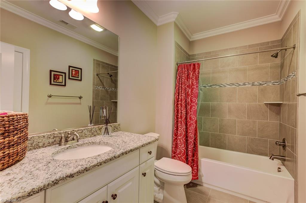 7500 Hearthridge Court Oak Ridge, NC 27310 - Photo 21 of 30 Another full bath with granite vanity, tile surround and cast iron tub.