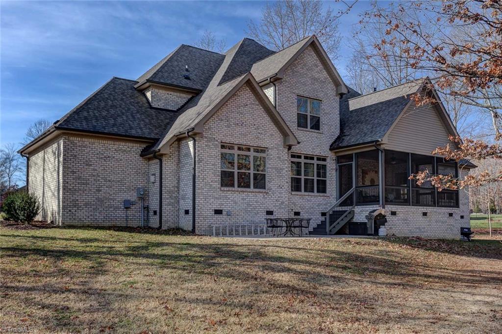 7500 Hearthridge Court Oak Ridge, NC 27310 - Photo 27 of 30 A view of the back of the home. Notice the large patio space ideal for grilling and outdoor entertaining.