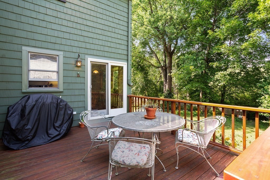 14 Rainbow Road Marblehead, MA 01945 - Photo 12 of 41 a view of a patio with table and chairs with wooden floor and fence