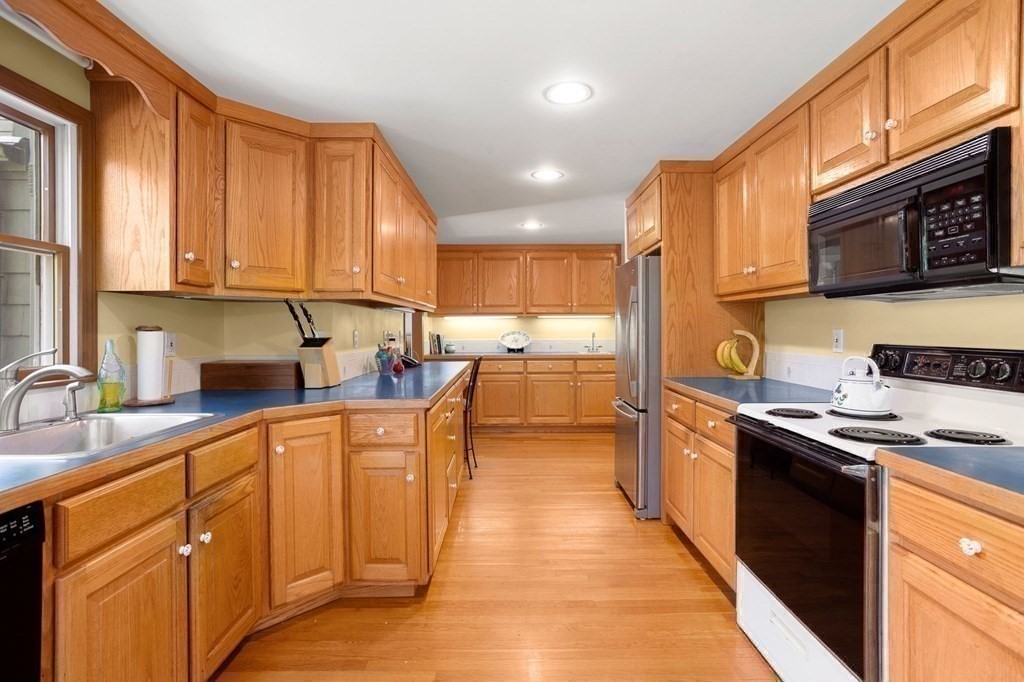14 Rainbow Road Marblehead, MA 01945 - Photo 19 of 41 a kitchen with stainless steel appliances granite countertop sink stove top oven and cabinets