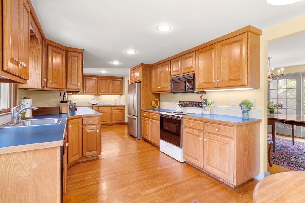 14 Rainbow Road Marblehead, MA 01945 - Photo 20 of 41 a kitchen with stainless steel appliances granite countertop wooden cabinets a stove top oven a sink and dishwasher