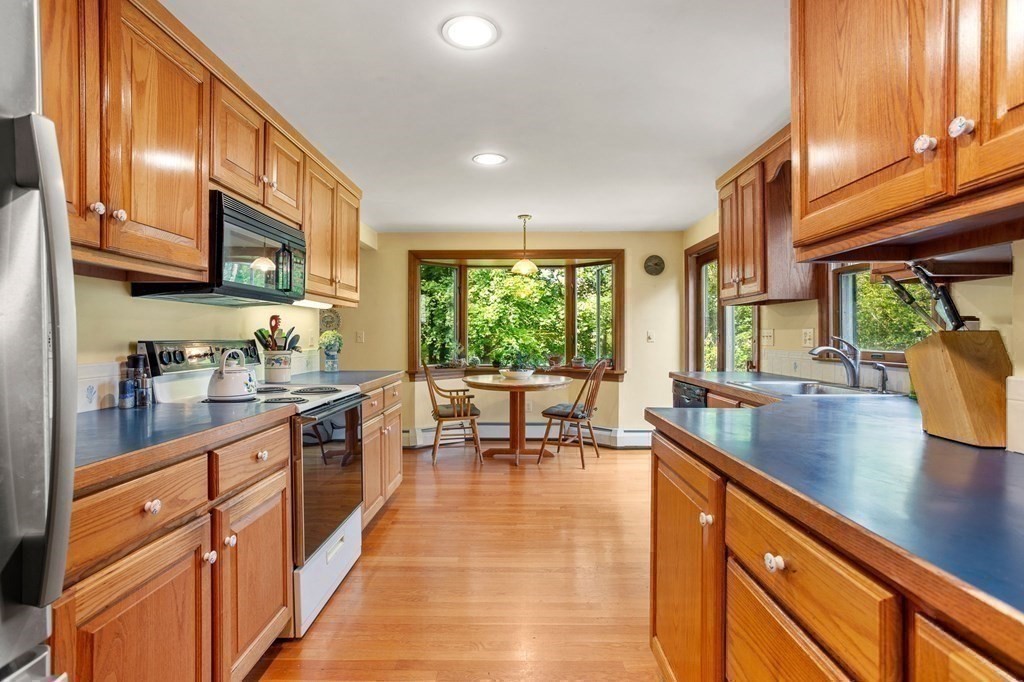 14 Rainbow Road Marblehead, MA 01945 - Photo 21 of 41 a kitchen with stainless steel appliances granite countertop sink stove top oven and cabinets