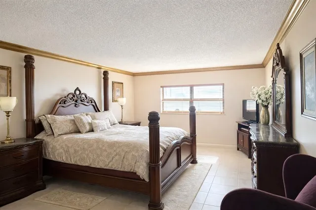 a bedroom with a large bed couch and a window