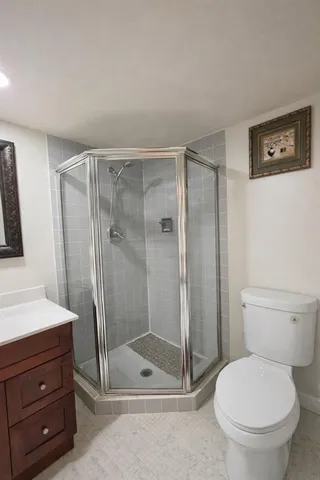 a bathroom with a shower a toilet and a sink
