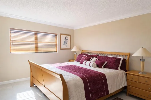 a bedroom with a bed and a lamp