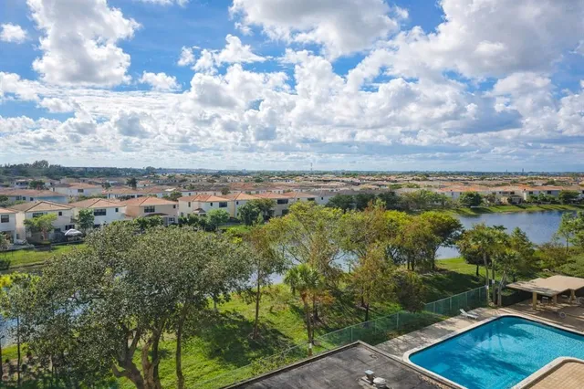 a view of a city with lush green forest