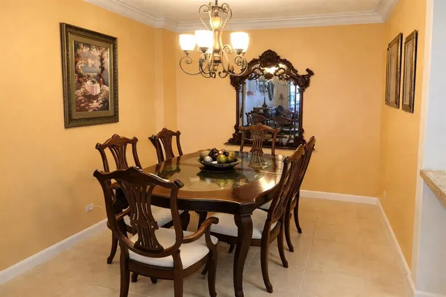 a view of a dining room with furniture and chandelier