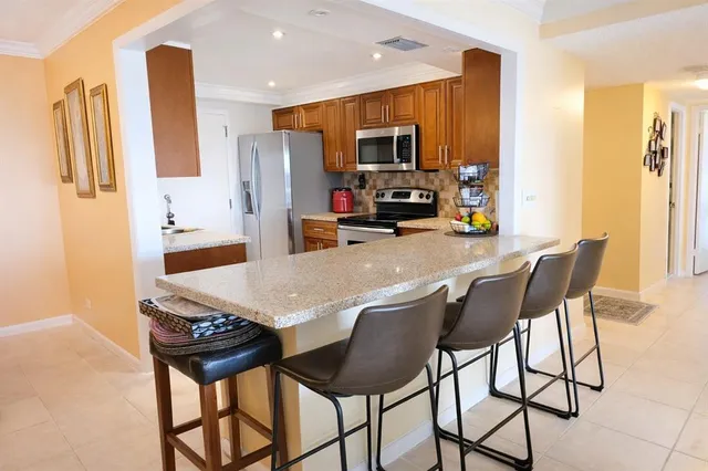 a view of a dining room with furniture and a flat screen tv