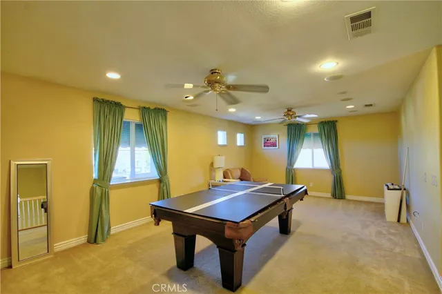 a room with pool table and a chandelier